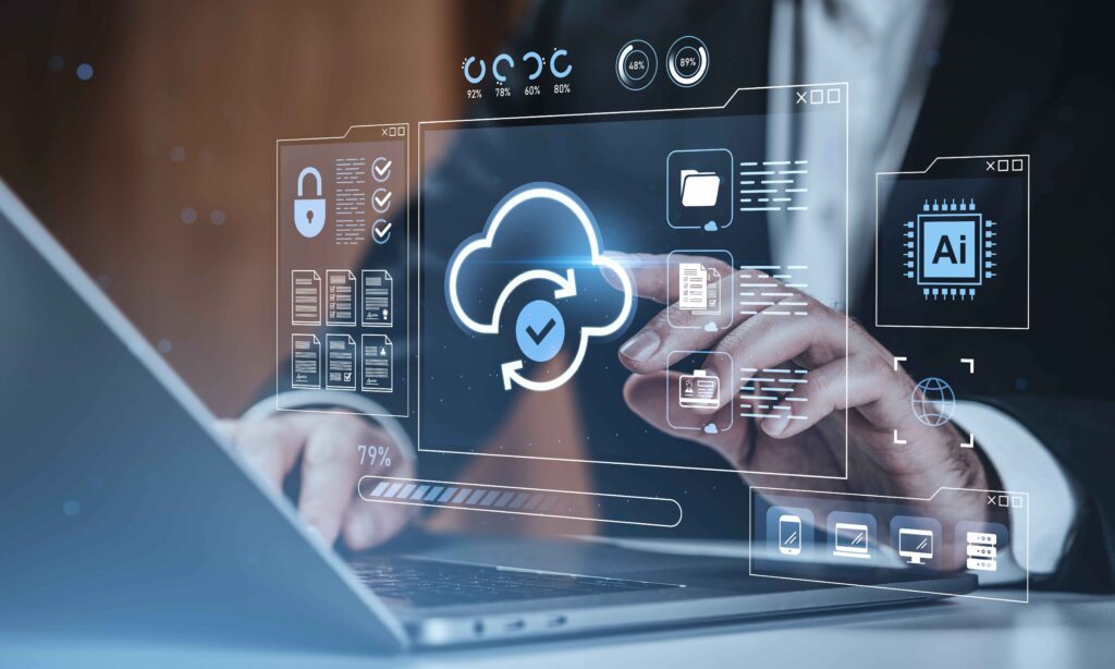 Businessman using laptop with holographic interface showing cloud storage, security icons, and folders on tech background, concept of data protection